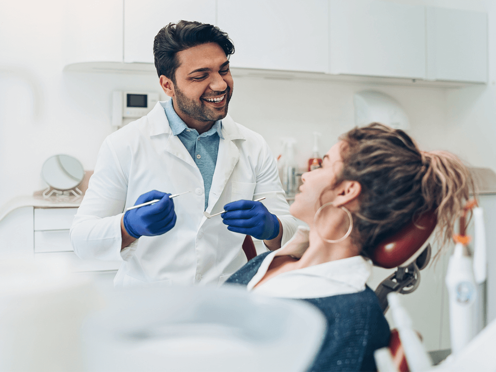 dentist about to check a woman's teeth