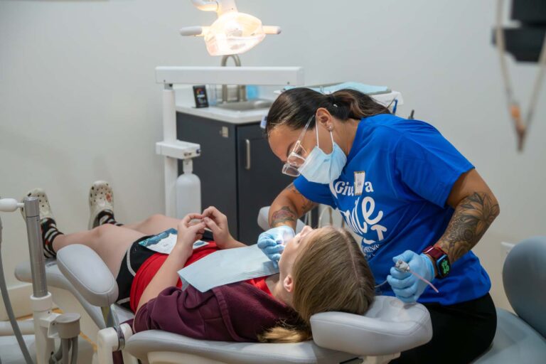 Dental professional and a patient on s dental during dental cleaning